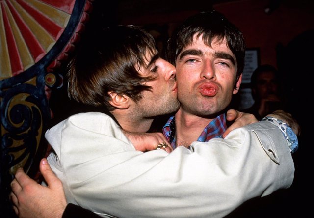 Liam Gallagher (l) kisses brother Noel after Oasis performed at London's Earls C
