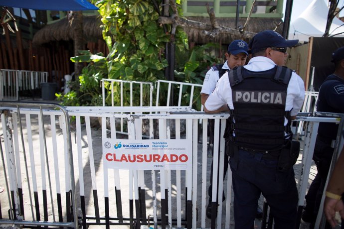 Police officers stand guard outside the Blue Parrot nightclub after a gunman ope