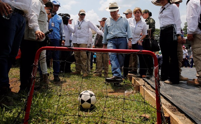 Colombia's President Juan Manuel Santos kicks a soccer ball into a goal during a