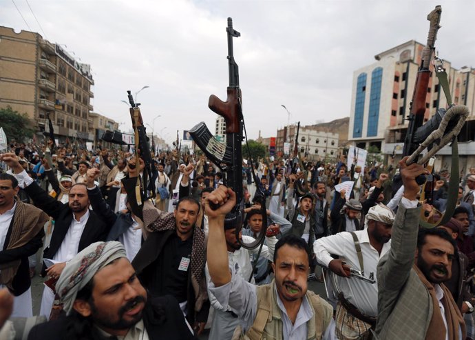 Followers of the Houthi movement shout slogans 