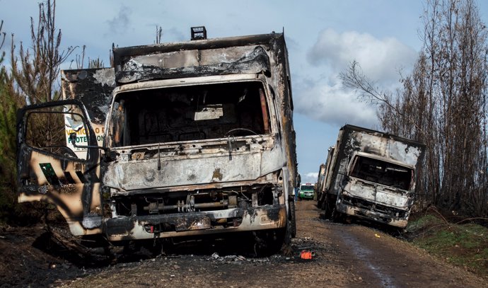 Burnt-out trucks are pictured on a rural road near Angol town, Temuco city, sout