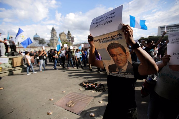 A man demands the resignation of Guatemala President Jimmy Morales during a prot