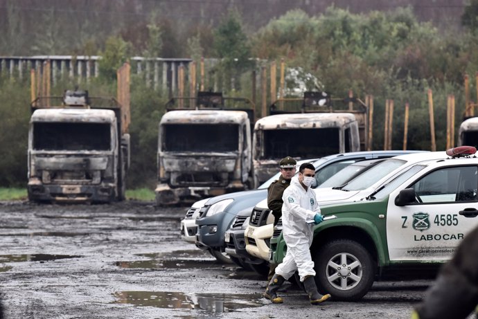 Burnt-out trucks are pictured in the San Jose de La Mariquina commue, south of S