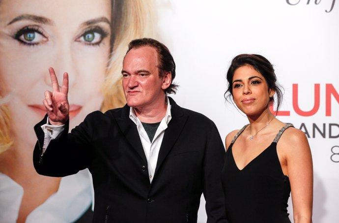 Director Quentin Tarantino (L) and model and singer Daniella Pick arrive at the 