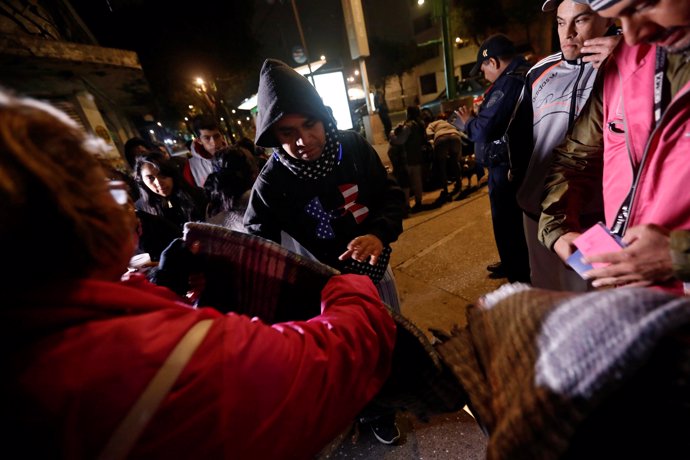 People gather on a street as they receive blankets after an earthquake hit Mexic