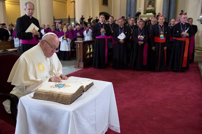 Pope Francis signs a book at the Bogota's cathedral in Bogota, Colombia Septembe