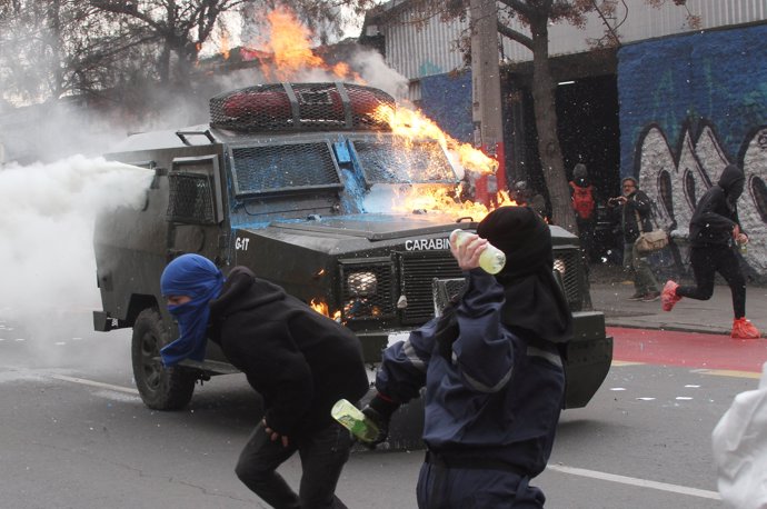 Demonstrators clash with riot police during a protest marking the 44th anniversa