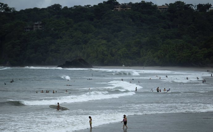 Tourists spend their day in the sea on the beach at Manuel Antonio National Park