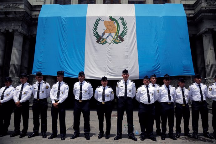Police stand guard outside Guatemala's Congress during an anti-government protes