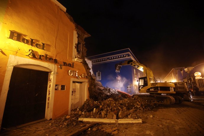 A machine works on a destroyed hotel after an earthquake hit Atlixco, in Puebla 