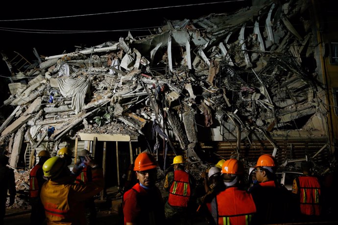 Rescuers work at a the site of a collapsed building after an earthquake in Mexic