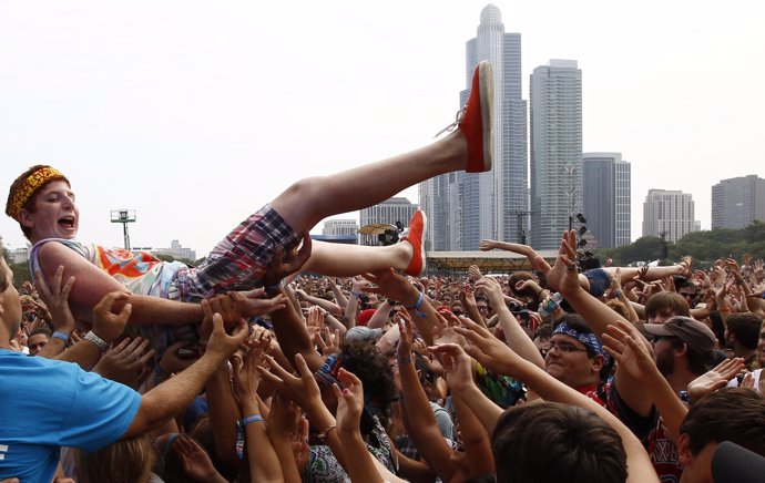 A music fan crowd surfs during a performance by "Foster the People" at the Lolla