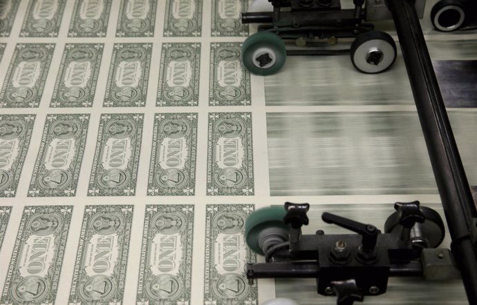 Sheets of United States one dollar bills are seen during the production process 