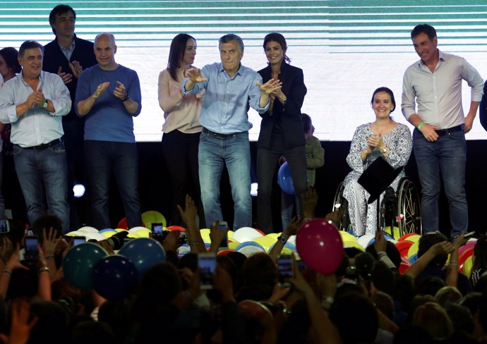 Argentina's President Mauricio Macri dances as he celebrates at their campaign h