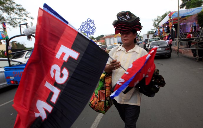 A man sells Nicaraguan flags and flags of the Sandinista National Liberation Fro