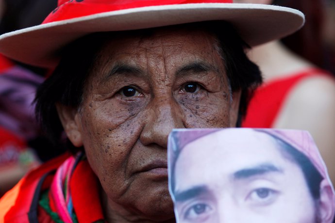 A Mapuche Indian activist holds a portrait of Rafael Nahuel during a demonstrati