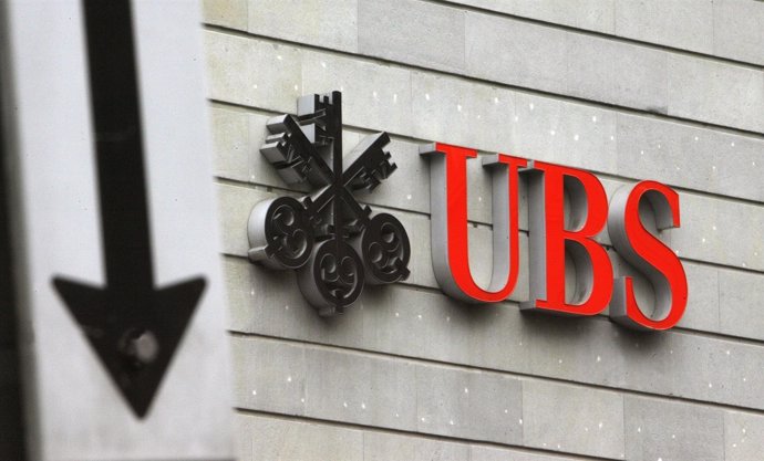 A traffic sign stands in front of the logo of Swiss bank UBS at the Bahnhofstras