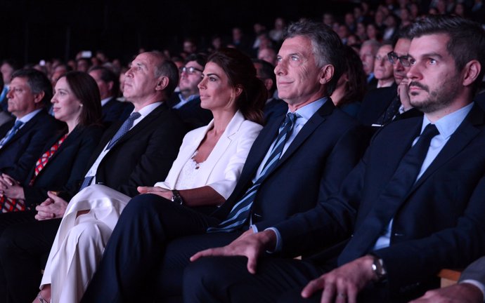 Argentina's President Mauricio Macri, alongside Cabinet Chief Marcos Pena (R), F