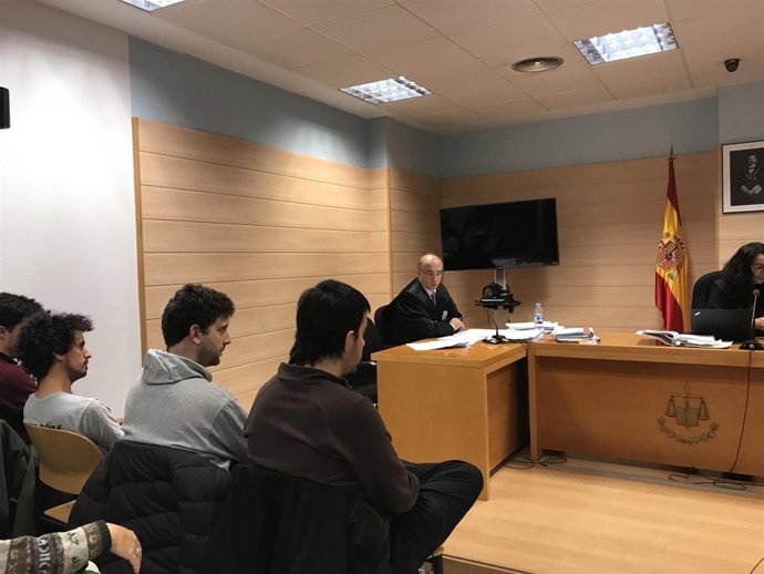 Varios de los acusados frente al fiscal, mientras éste interviene en el juicio