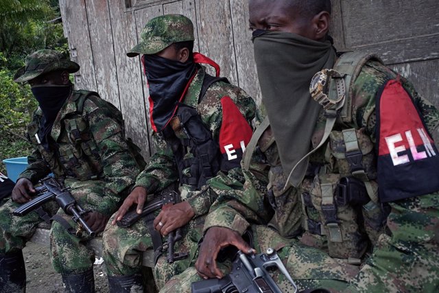 Rebels from Colombia's Marxist National Liberation Army (ELN) take a rest outsid