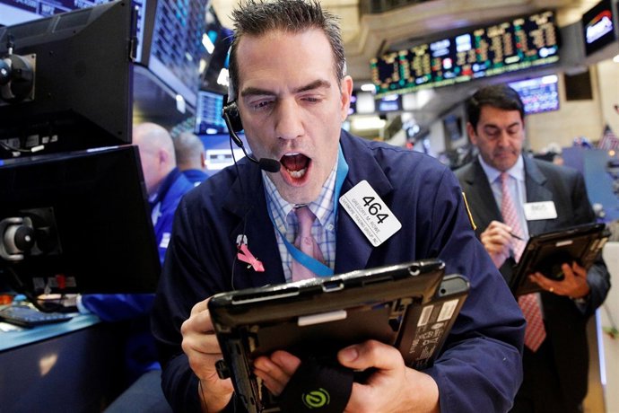 Traders work on the floor of the New York Stock Exchange (NYSE) in New York City
