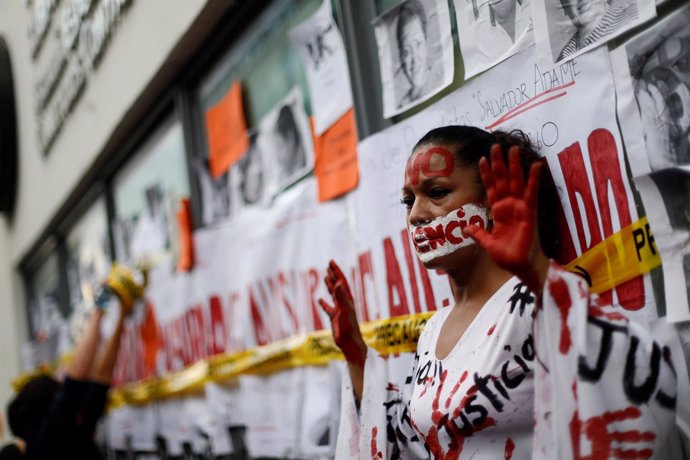 An activist takes part in a demonstration against the murder of journalists in M