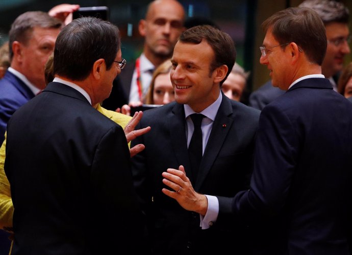 French President Emmanuel Macron (C) is greeted by President of Cyprus Nicos Ana