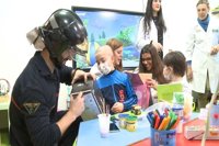 Miembros de AECC y de bomberos de Badajoz entregan juguetes a niños ingresados en el Hospital Materno Infantil