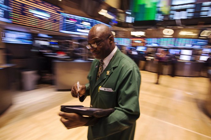 A trader works on the floor of the New York Stock Exchange after the closing bel