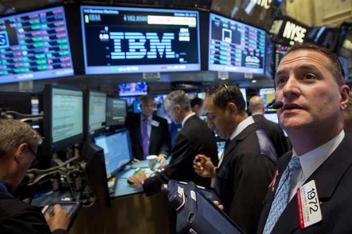 Traders gather at the post that trades IBM on the floor of the New York Stock Ex