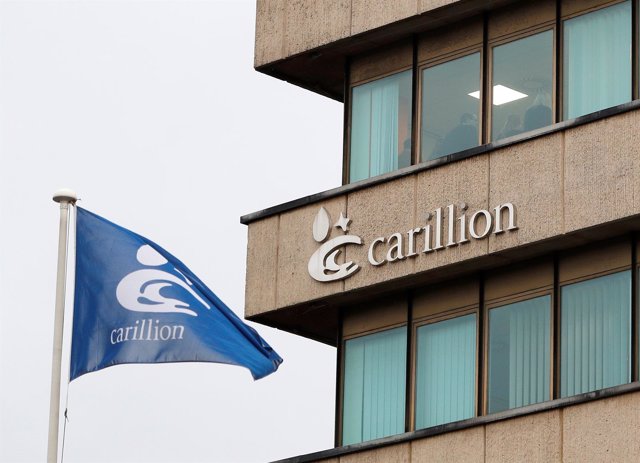 Workers at Carillion stand in an office after the company went into liquidation,