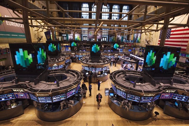 Traders work after the closing bell on the floor of the New York Stock Exchange,