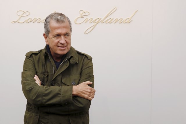 Photographer Mario Testino arrives for the Burberry catwalk show at London Fashi