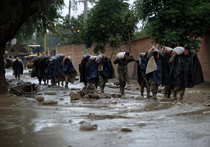 Soldier carry bags of sand during floods due to heavy rains, in Tiquipaya, Cocha