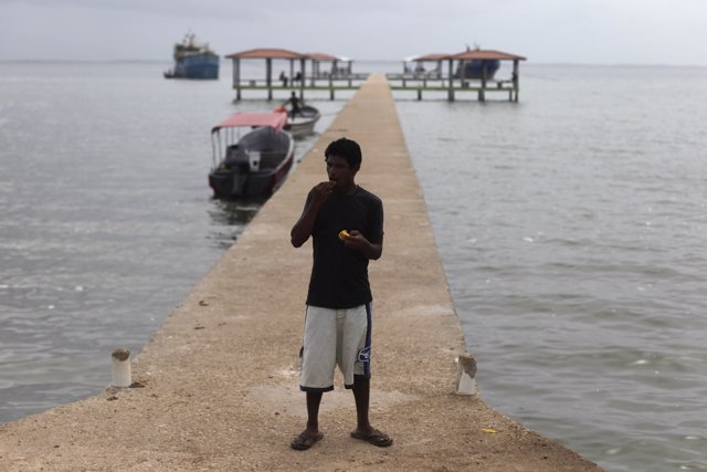 A man eats fruit at the dock of Puerto Lempira, on the Mosquito coast of northea