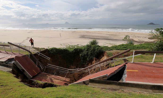 The collapsed area of a cycle lane is seen on Sao Conrado beach after heavy rain