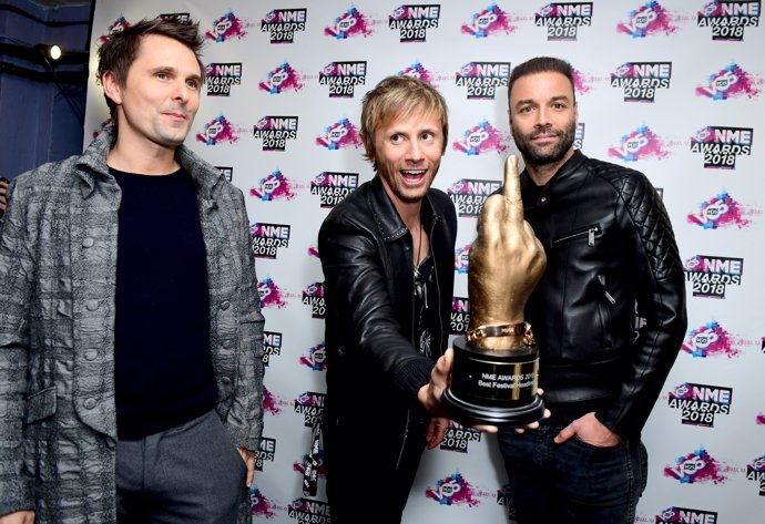 Matt Bellamy, Chris Wolstenholme and Dominic Howard of Muse holding the award fo