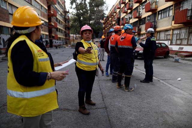 People react after an earthquake shook buildings in Mexico City, Mexico February