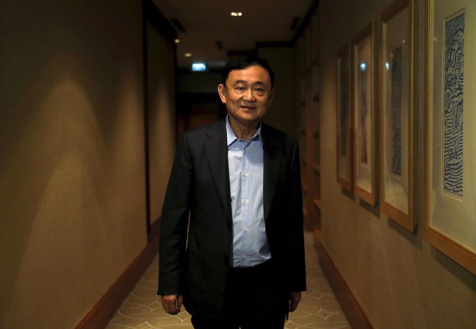 Former Thai Prime Minister Thaksin Shinawatra leaves after an interview with Reu