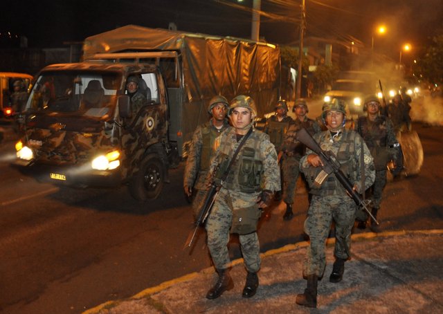 Army soldiers arrive just before clashing with striking police outside a hospita