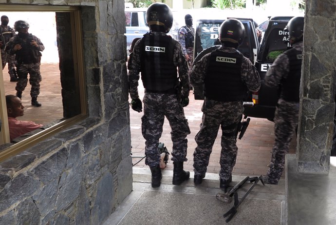 Members of the Bolivarian National Intelligence Service (SEBIN) are seen outside