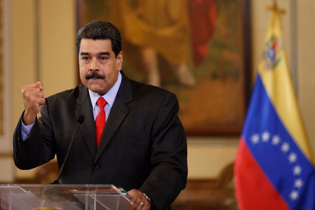 Venezuela's President Nicolas Maduro gestures as he talks to the media during a 