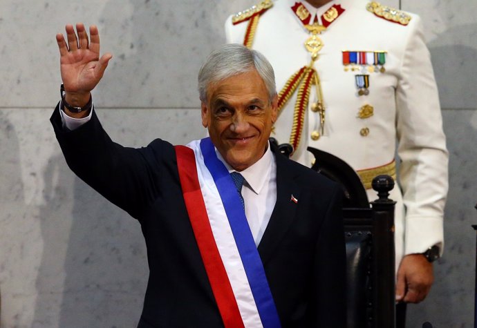 Chile's President Sebastian Pinera waves after being sworn in at the Congress in