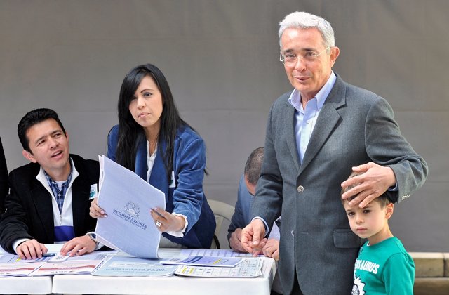 Colombian former President Alvaro Uribe casts his vote during the legislative el