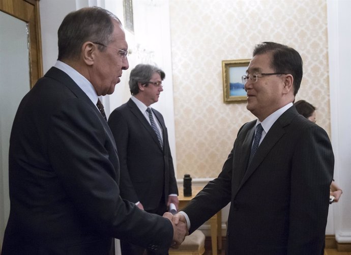 Russia's Foreign Minister Sergei Lavrov (L) shakes hands with South Korea's Nati