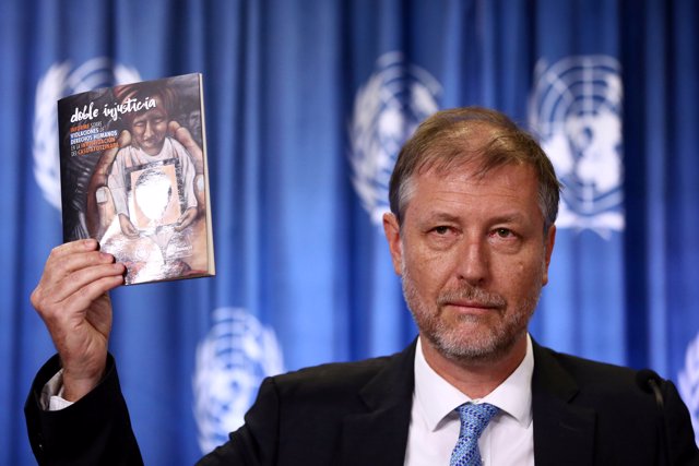 Jan Jarab, the UN High Commissioner for Human Rights in Mexico, holds a book dur