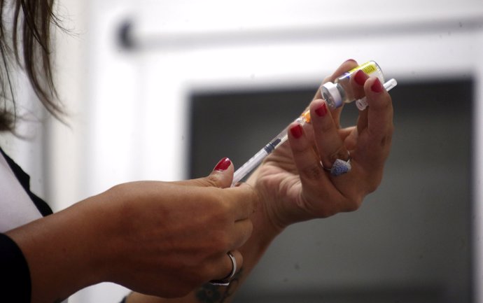 A health agent prepares a vaccine during a campaign of vaccination against yello