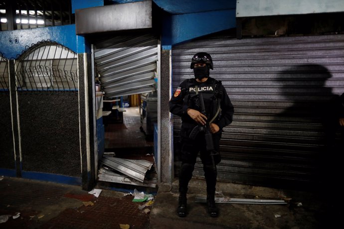 A policeman secure a seized MS-13 gang related store during the Operation Cuscat