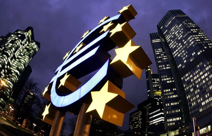 The illuminated euro sculpture is seen in front of the European Central Bank's (