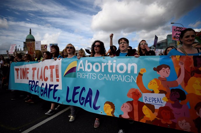 FILE PHOTO: Demonstrators hold posters as they march for more liberal Irish abor